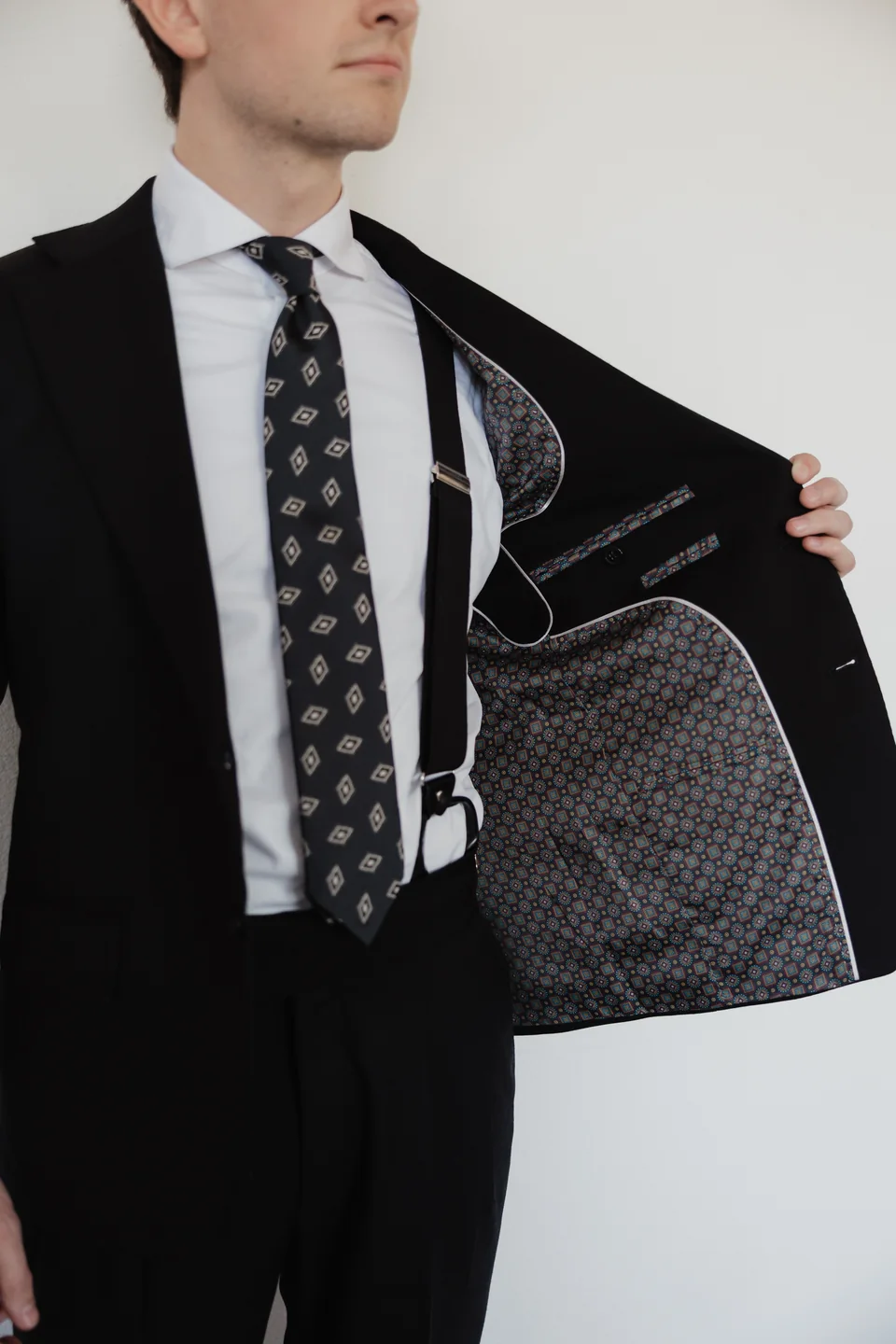 Dark jacket opened to show its patterned interior lining.