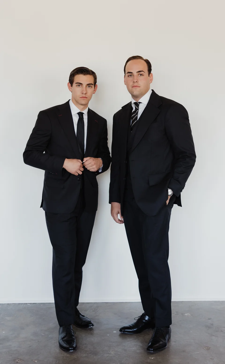 Two full-length dark suits.