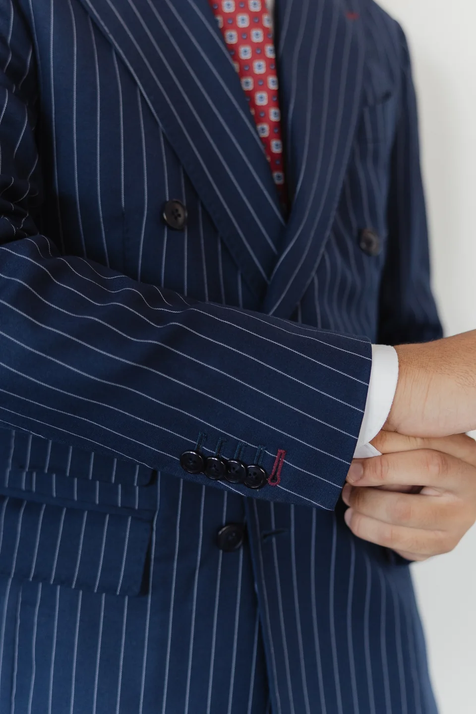Pinstripe jacket sleeve and cuff detail.