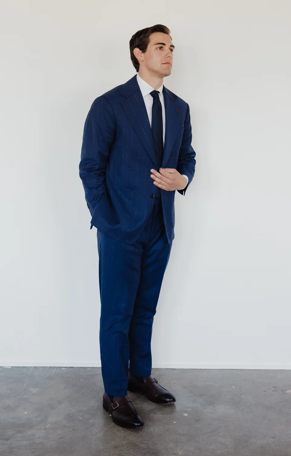 Full-length blue suit with the trouser break and shoes visible.