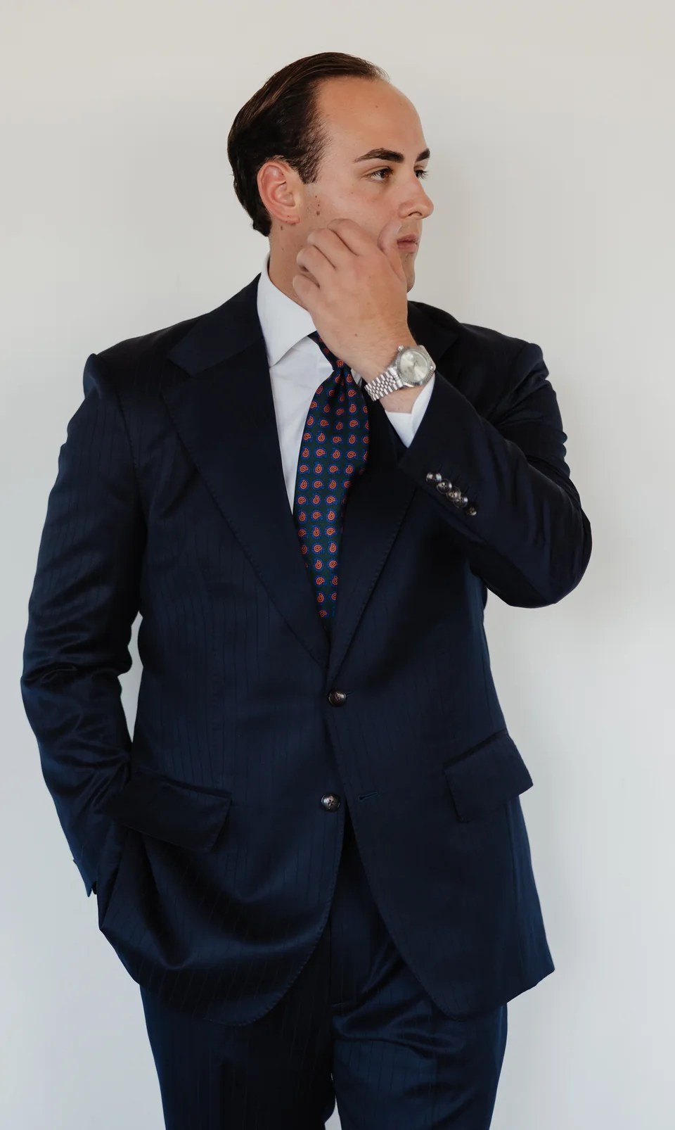 Navy suit portrait with a patterned tie.