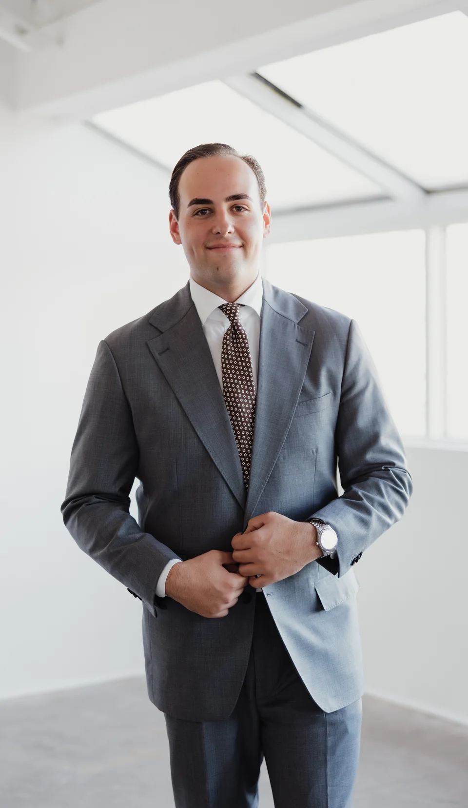 Gray suit portrait with a patterned tie.